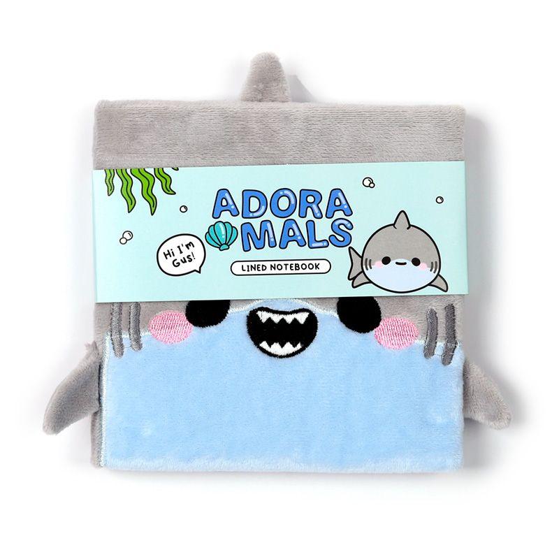 Caderno fofo em pelúcia de tubarão cinza com uma faixa ilustrativa apresentando um tubarão sorridente.