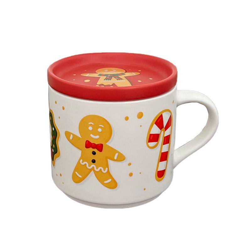 Caneca de Natal em ceramica branca com desenhos de homem de gengibre e bastão de doces, inclui tampa que serve como base para copos.