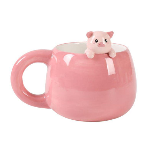 Caneca rosa em cerâmica com figura de porquinho a espreitar na borda.